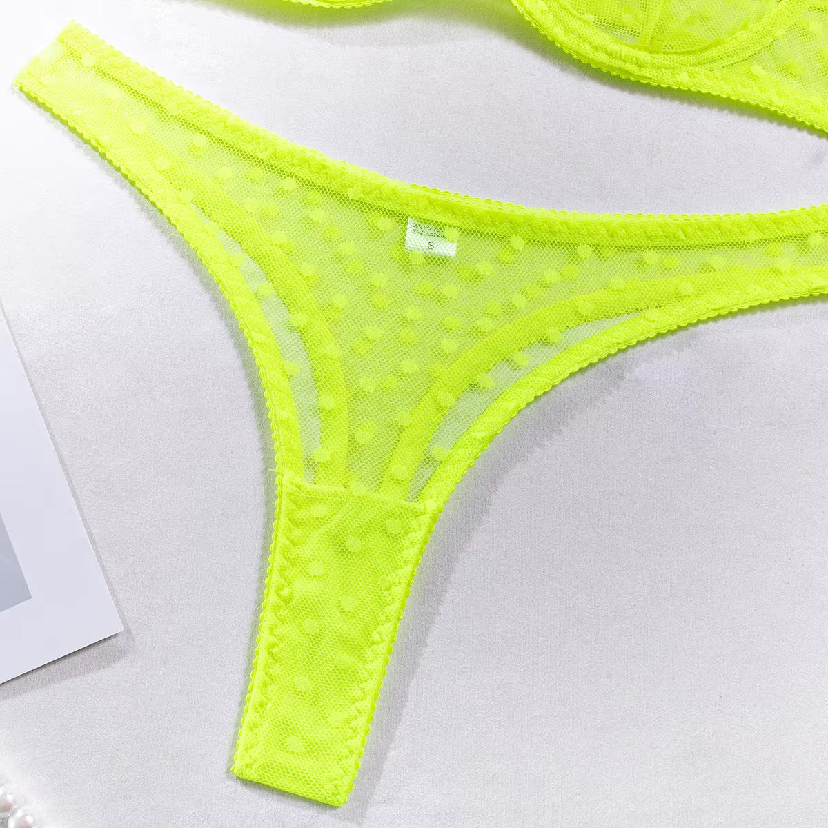Neon green thong with sheer dot mesh and flattering seamless fit