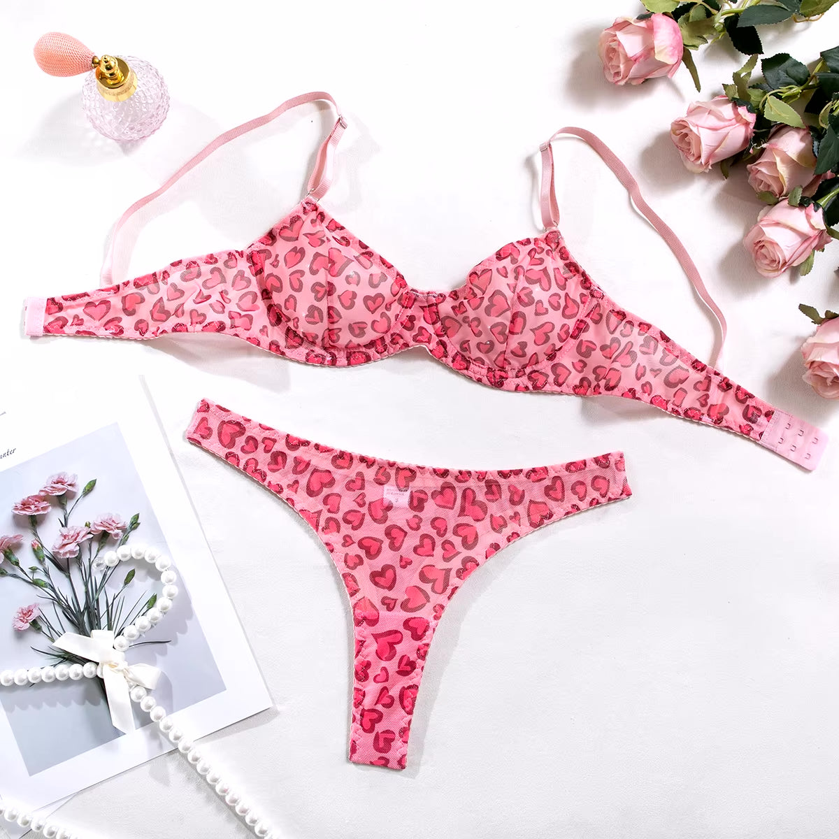 Delicate pink heart mesh lingerie duo with supportive bra and cheeky thong