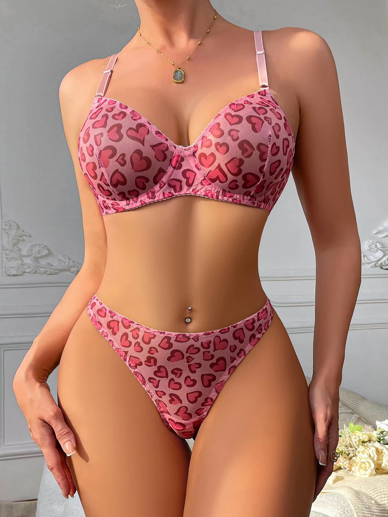 Chic pink mesh lingerie set with heart details and underwired support