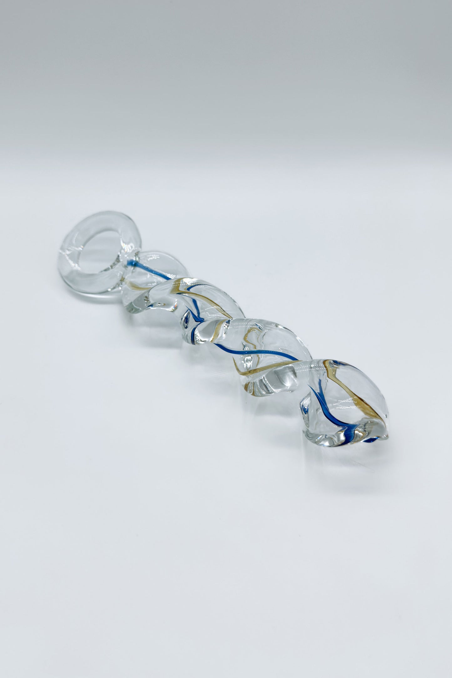 Crystal glass butt plug featuring spiral texture and ring base