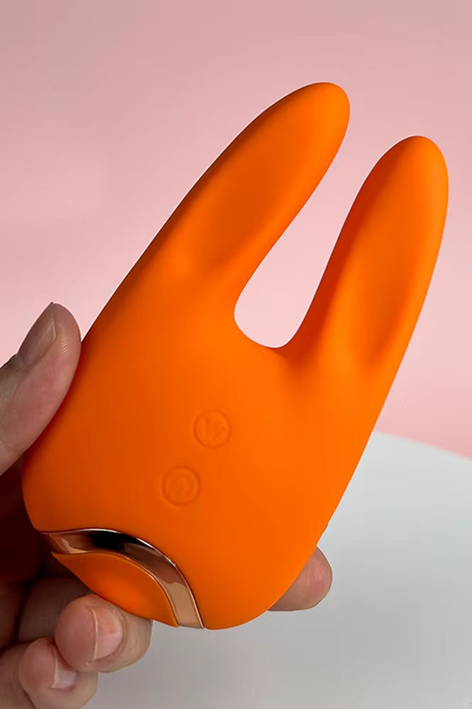 Dual sensation rabbit vibrator with suction base and flexible ears, orange design