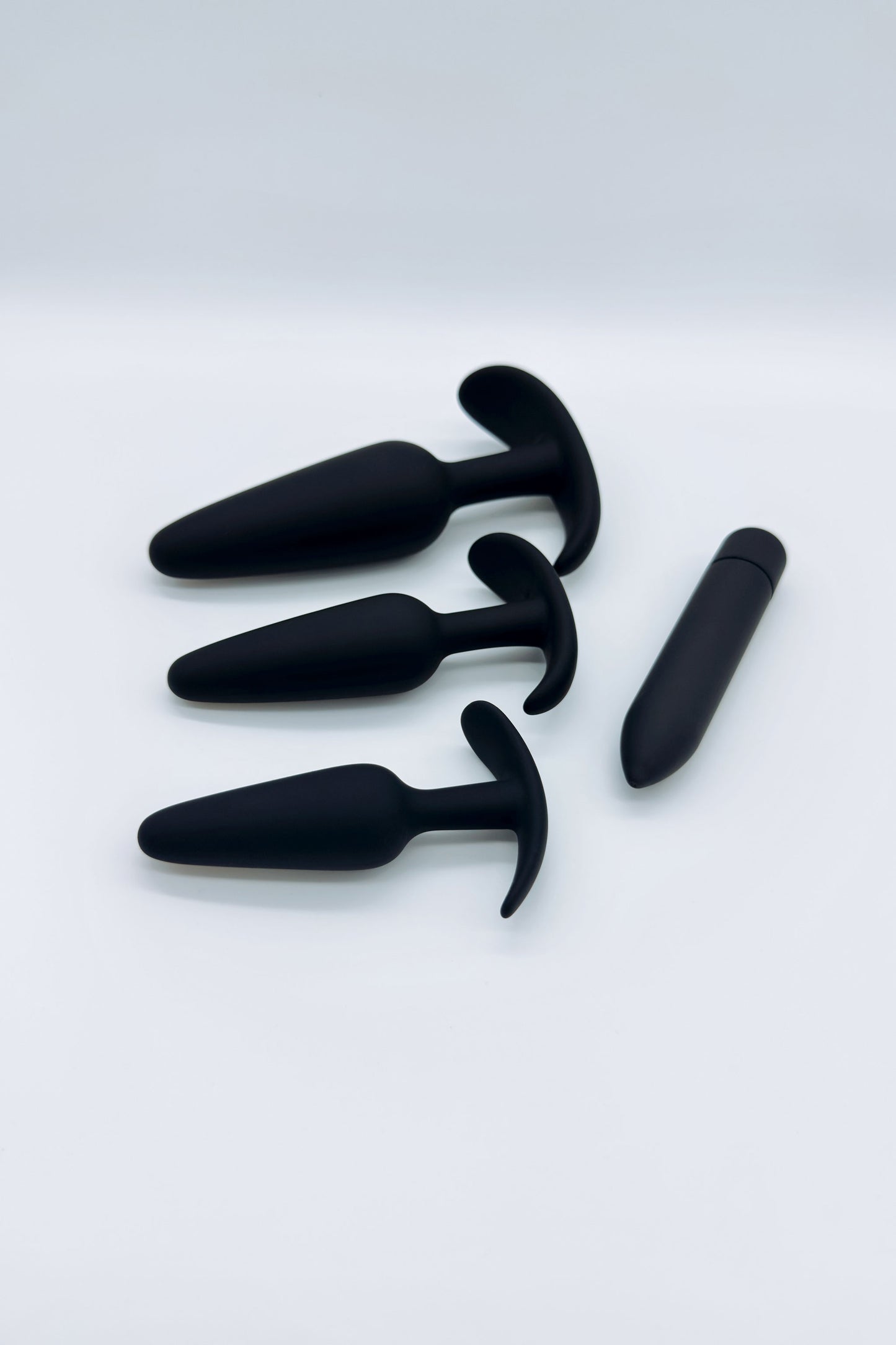 Three tapered anal plugs in small, medium, and large sizes