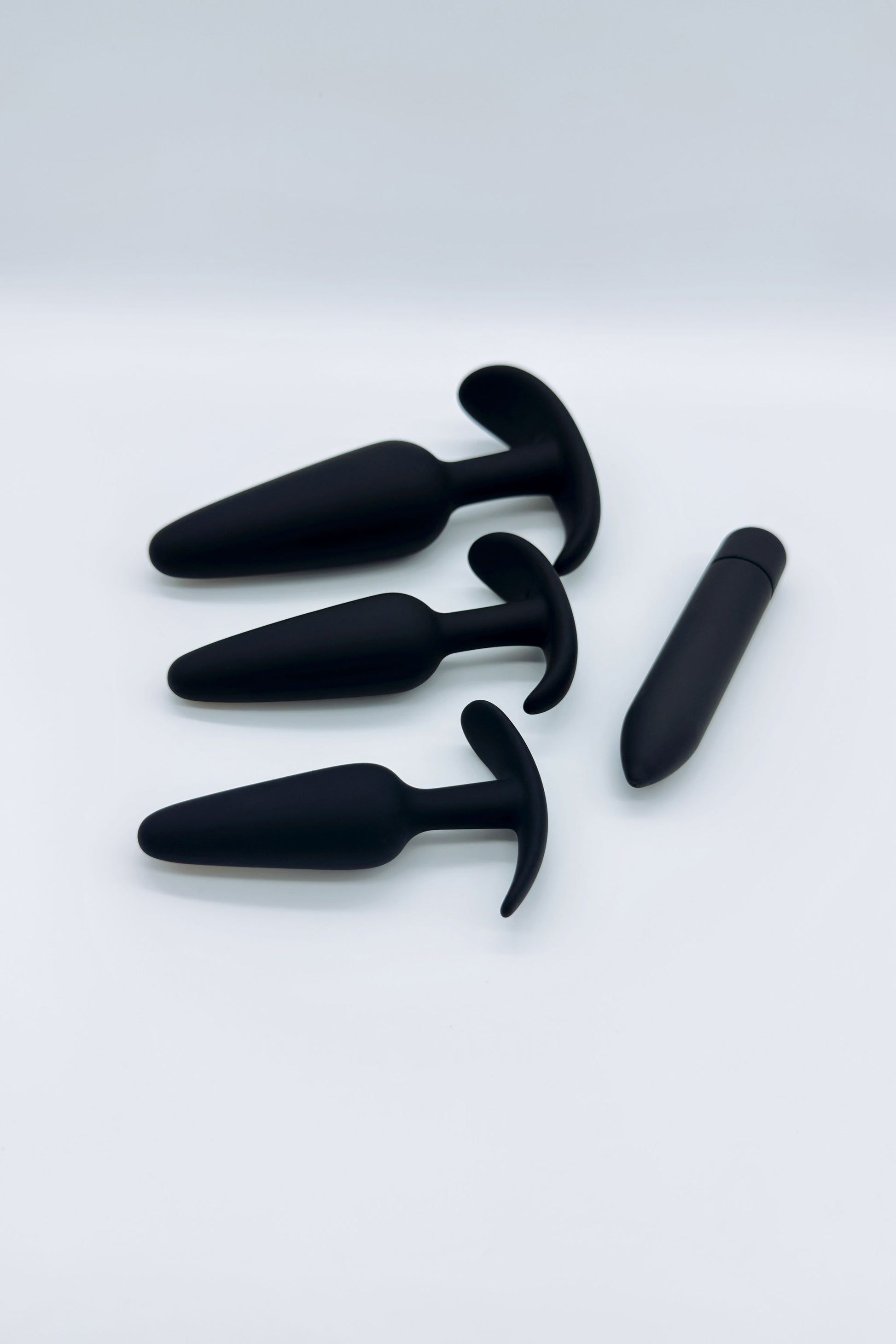 Three tapered anal plugs in small, medium, and large sizes