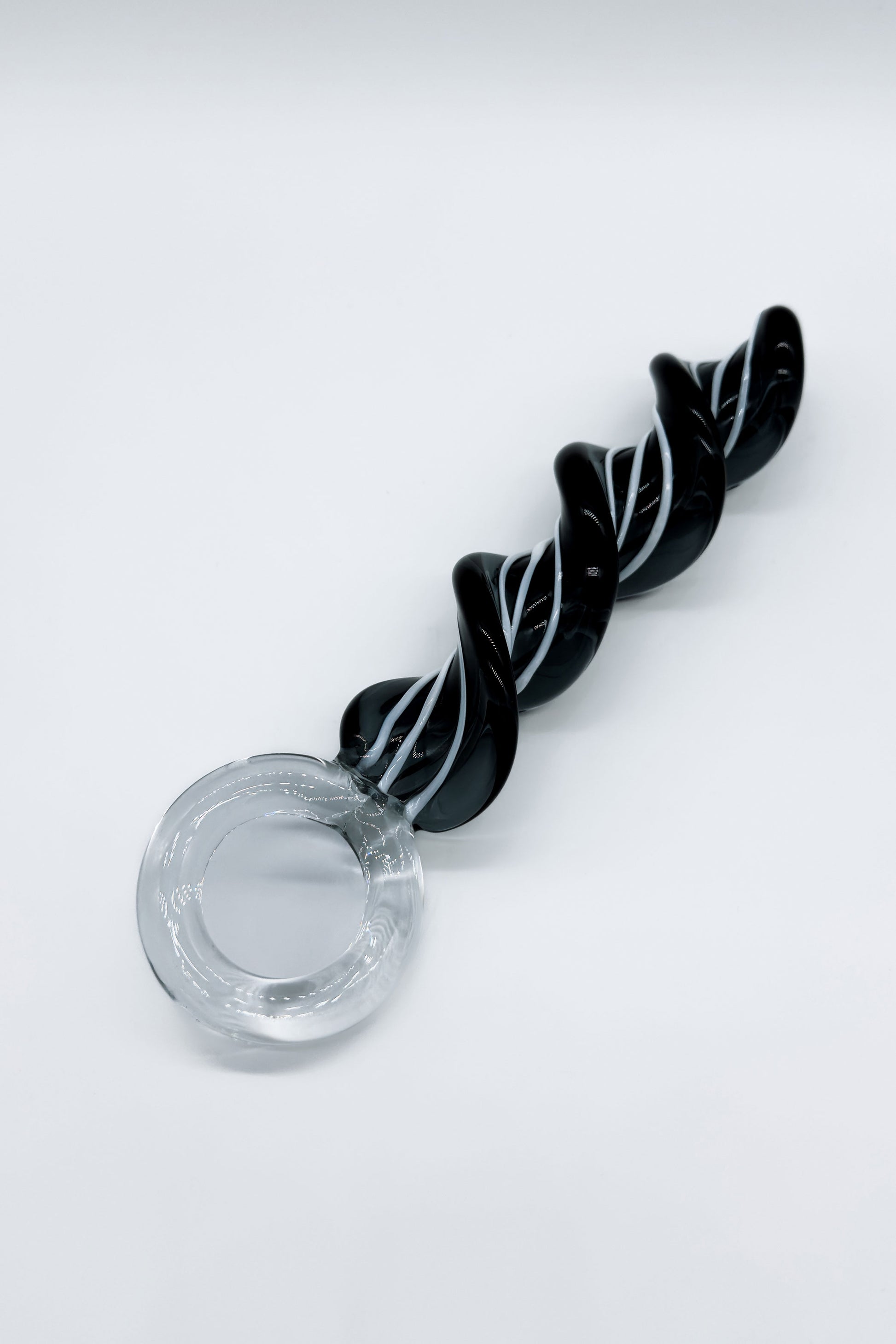 Twisted glass butt plug showing ring base for safe handling